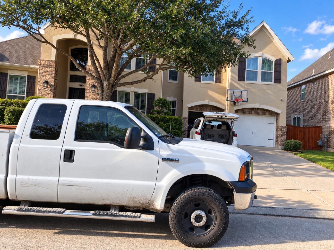 Freedom F-250 service truck parked at a customer's home for a driveway repair