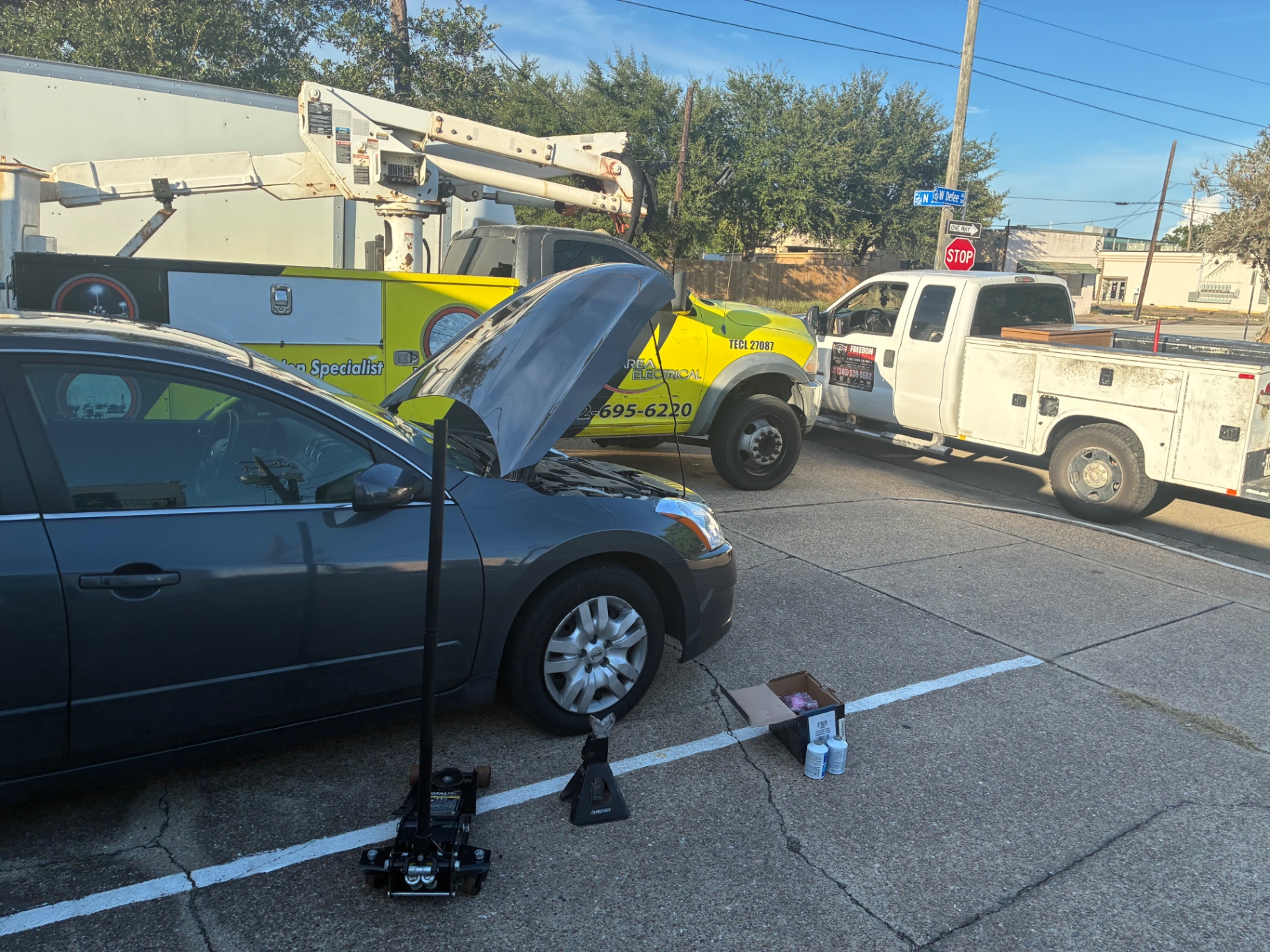 Nissan Altima on jack stands during a street-side repair